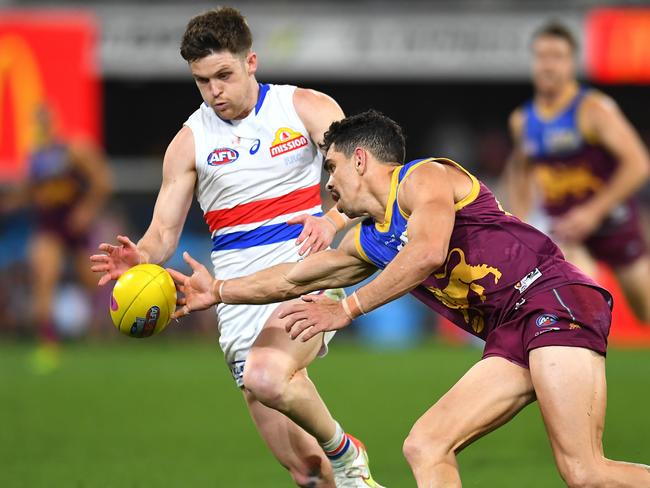 Taylor Duryea (left) contained Lions forward Charlie Cameron with aplomb on Saturday night. Picture: Albert Perez/AFL Photos via Getty Images