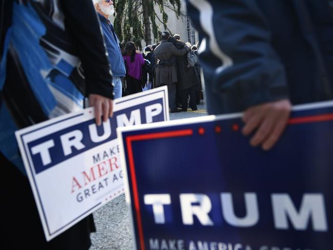 People hold signs outside the Tree of Life Congregation in Pittsburgh, Pennsylvania, during a controversial visit by President Donald Trump and his wife Melania. Picture: AFP