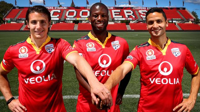 Bruce Djite (centre) with Michael Marrone and Marcelo Carrusca in 2015 during his playing days with Adelaide United. Picture: Sarah Reed