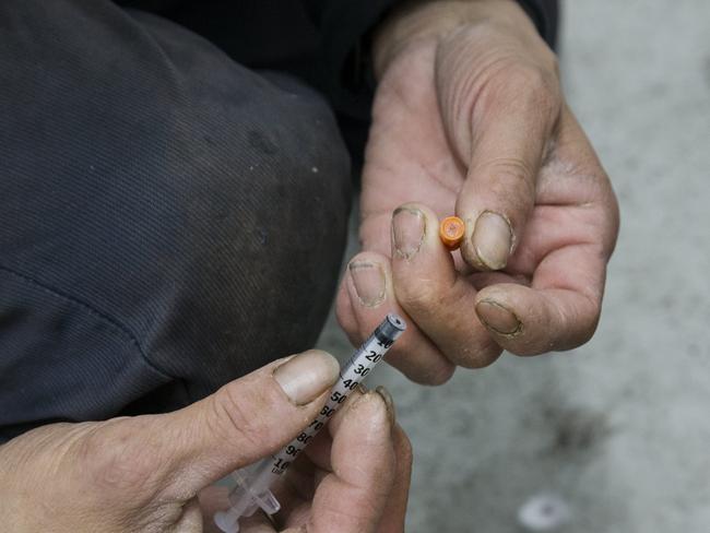 After injecting heroin Vinny breaks the needle off the syringe. Picture: Ian Currie