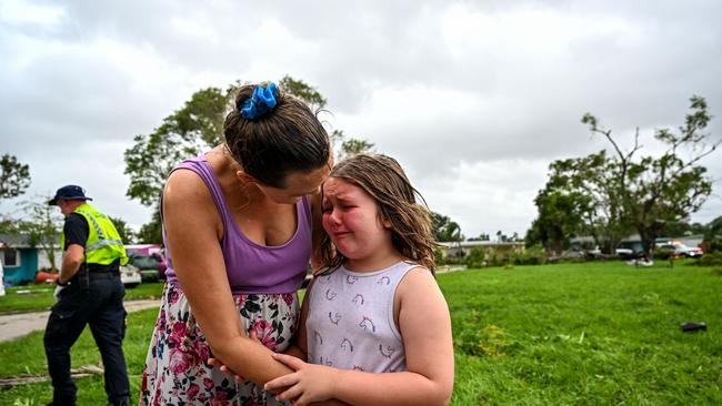 Samantha Dubberly consoles her daughter Alexa Haight as medics takes her grandfather into care after he got injured by a reported tornado that hit his house in Fort Myers, Florida on October 9. Picture: Chandan Khanna/AFP