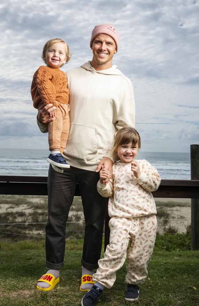 Pro surfer Julian Wilson relaxes with his children River, 18 months, and Olivia 3, in Coolum Beach before heading to the Tokyo Olympics. Picture: Lachie Millard