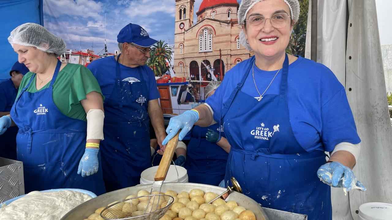 Volunteer Despina Grimekis (right) prepares delicious loukoumades.