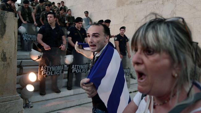 People demonstrate in front of the stairs leading to the Greek parliament in Athens during an anti-EU demonstration in Athens calling for a 'NO' to any agreement with the creditors on July 13, 2015. Eurozone leaders struck a deal Monday on a bailout to prevent debt-stricken Greece from crashing out of the euro, forcing Athens to push through draconian reforms in a matter of days. AFP PHOTO / ANDREAS SOLARO