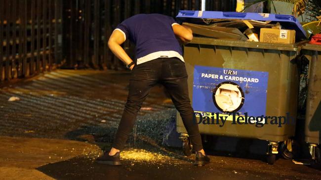 A Bulldogs player cuts a classy figure with a quick spew in the street. Picture: Christian Gilles