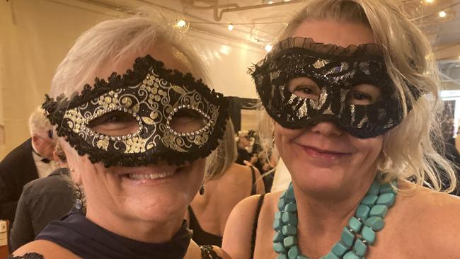 Michelle McArthur and Meaghan Kotzur celebrate at the Gympie RSL Masked Ball, April 29 2023.