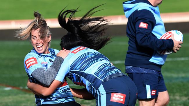 Sam Bremner of the NSW Blues Women's State of Origin team reacts as she is tackled to the ground by teammate Lavina O'Mealey during their captains run at the North Sydney Oval in Sydney, Thursday, June 21, 2018. (AAP Image/David Moir) NO ARCHIVING