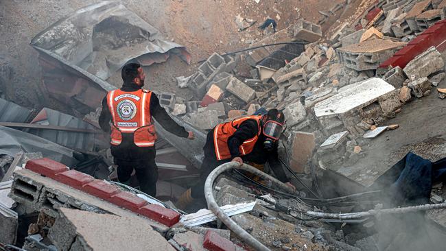 Members of the Palestinian civil defence extinguish a fire in a building following Israeli bombardments east of Rafah in the southern Gaza Strip. Picture: AFP