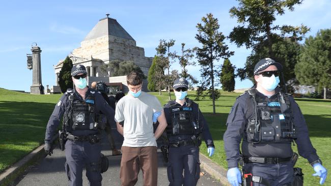 A man is arrested after an anti-mask protest in Melbourne. Picture: David Crosling / NCA NewsWire