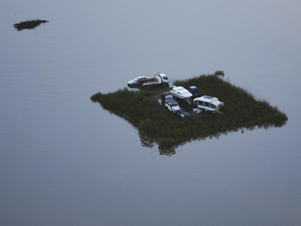 This bizarre image shows a patch of land with cars, a caravan and boat as seen from a helicopter in the Windsor area near Sydney. Picture: Lukas Coch/Pool/AAP