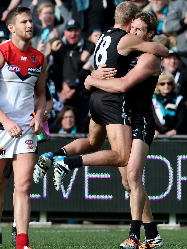 Jay Schulz is hugged by Port Adelaide teammate Kane Cornes after kicking the winning goal against Melbourne. Picture: Simon Cross