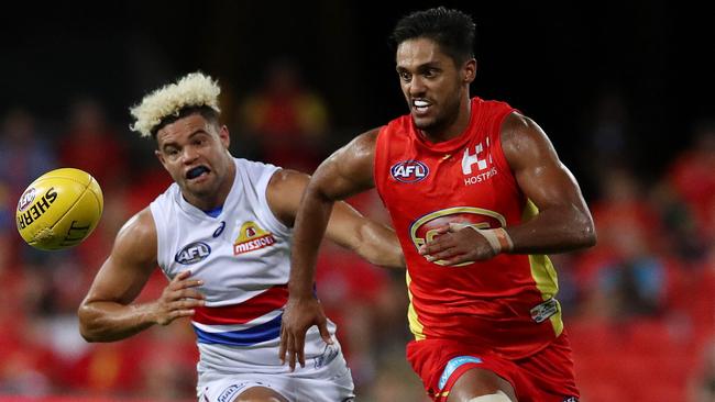 Aaron Hall races for the ball in front of Jason Johannisen. Picture: Scott Fletcher