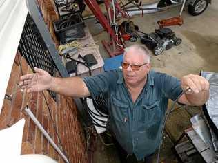 FRUSTING SITUATION: Jeff Beal displays the dodgy wiring going into his property from the stop gap measure to fix his phone line. Picture: Chris Ison ROK020218cline1