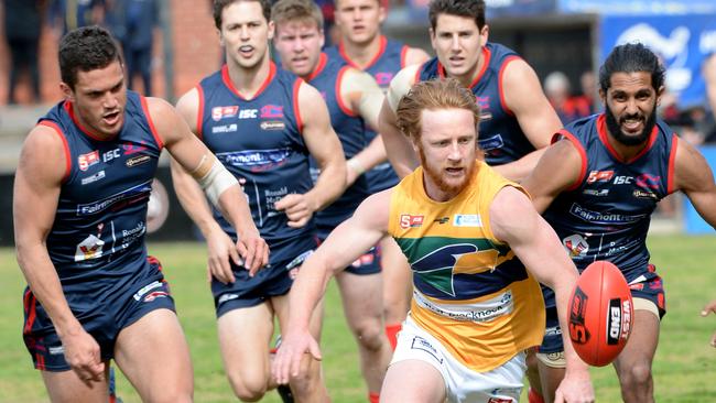 Eagles star Angus Poole ahead of a posse of Redleges including Anthony Wilson (right). Picture: Greg Higgs