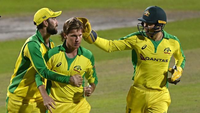 Australia's Adam Zampa (C) is congratulated by Australia's Glenn Maxwell (L) and Australia's wicket keeper Alex Carey (R) aftre taking the wicket of England's Jonny Bairstow. Picture: AFP