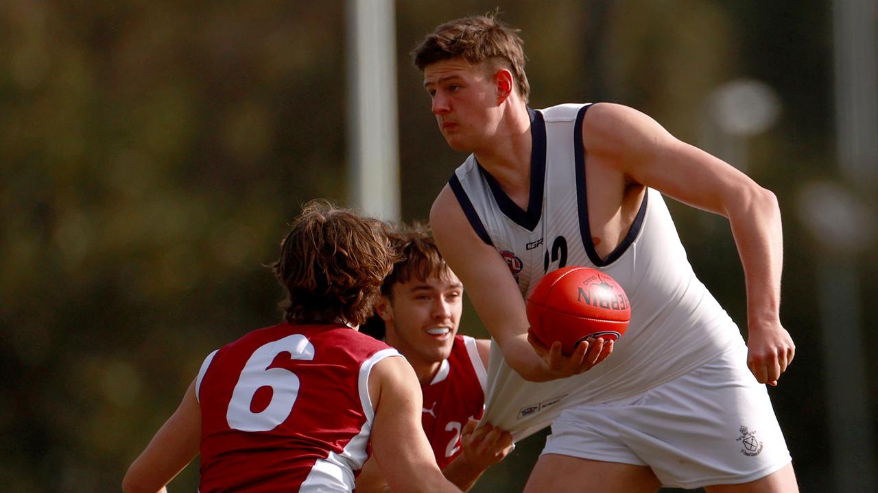 Vic Country’s Zac Harding tries to get a handball away against Queensland. Picture: Getty Images