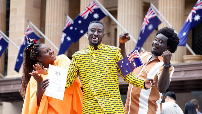 Isaac Boakye (centre) from Brisbane, originally from Ghana, with wife Angela Boakye and friend Michael Anang at Brisbane’s citizenship ceremony at City Hall on Sunday. Picture: Steve Pohlner