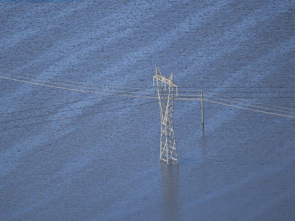 A power pole surrounded by floodwater is seen from a helicopter in flood affected areas in the Windsor and Pitt Town areas along the Hawkesbury River. Picture: AAP