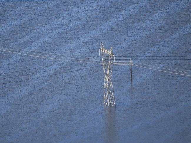 A power pole surrounded by floodwater is seen from a helicopter in flood affected areas in the Windsor and Pitt Town areas along the Hawkesbury River. Picture: AAP