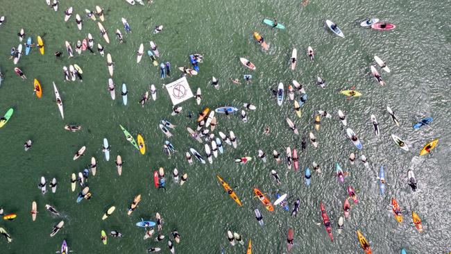 Protesters take to the water at Cremorne in a paddle-out opposing salmon farm expansion in Storm Bay. Picture: Supplied