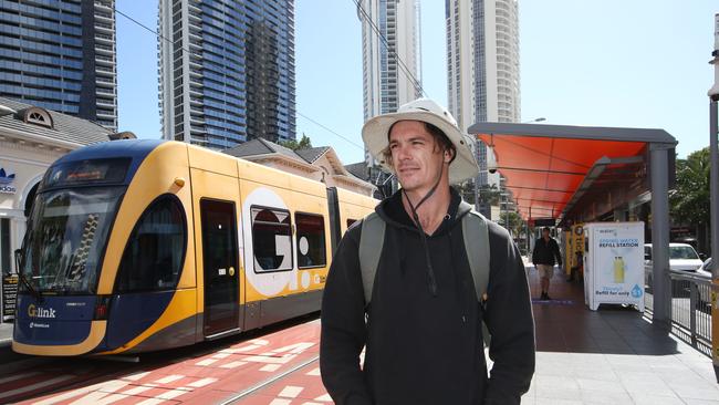 Josh Akehurst 27 from Broadbeach Waters gets off at the Light Rail station in Surfers Paradise. Picture Glenn Hampson