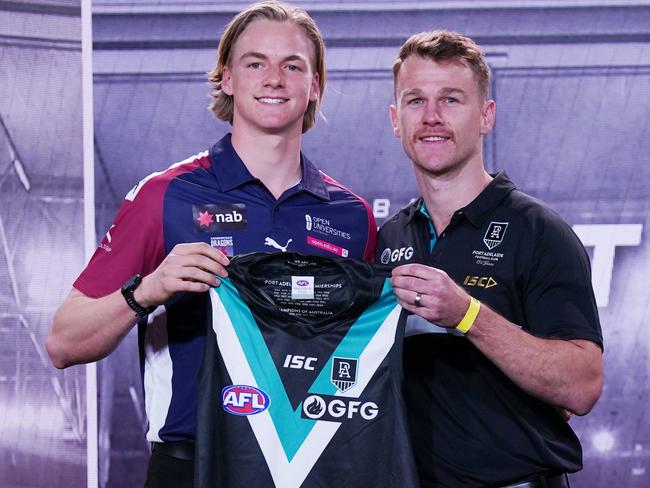 Miles Bergman (left) is presented with a jersey by Robbie Gray of the Power during the first round of the 2019 AFL Draft at Marvel Stadium in Melbourne, Wednesday, November 27, 2019. Picture: AAP Image/Michael Dodge