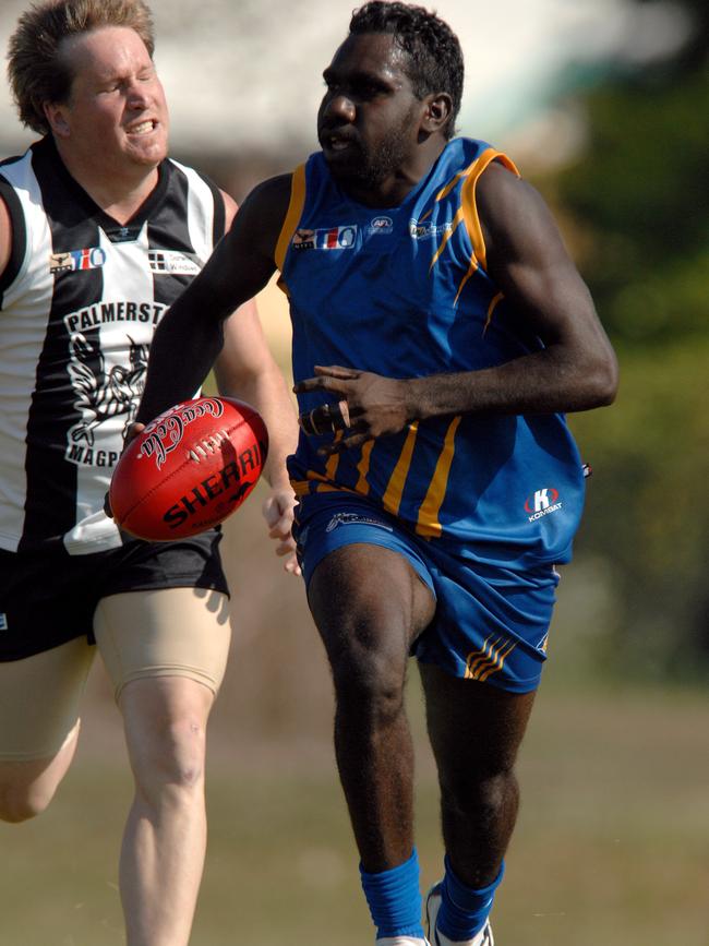 Relton Roberts races away from Palmerston's Andrew Watson during a NTFL match.