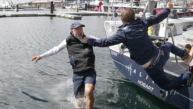 Skipper Duncan Hine of Alive goes into the water with Sam Tiedemann, crew member, holding on. Sydney to Hobart 2023 handicap and overall winner Tasmanian yacht Alive. Picture: Nikki Davis-Jones