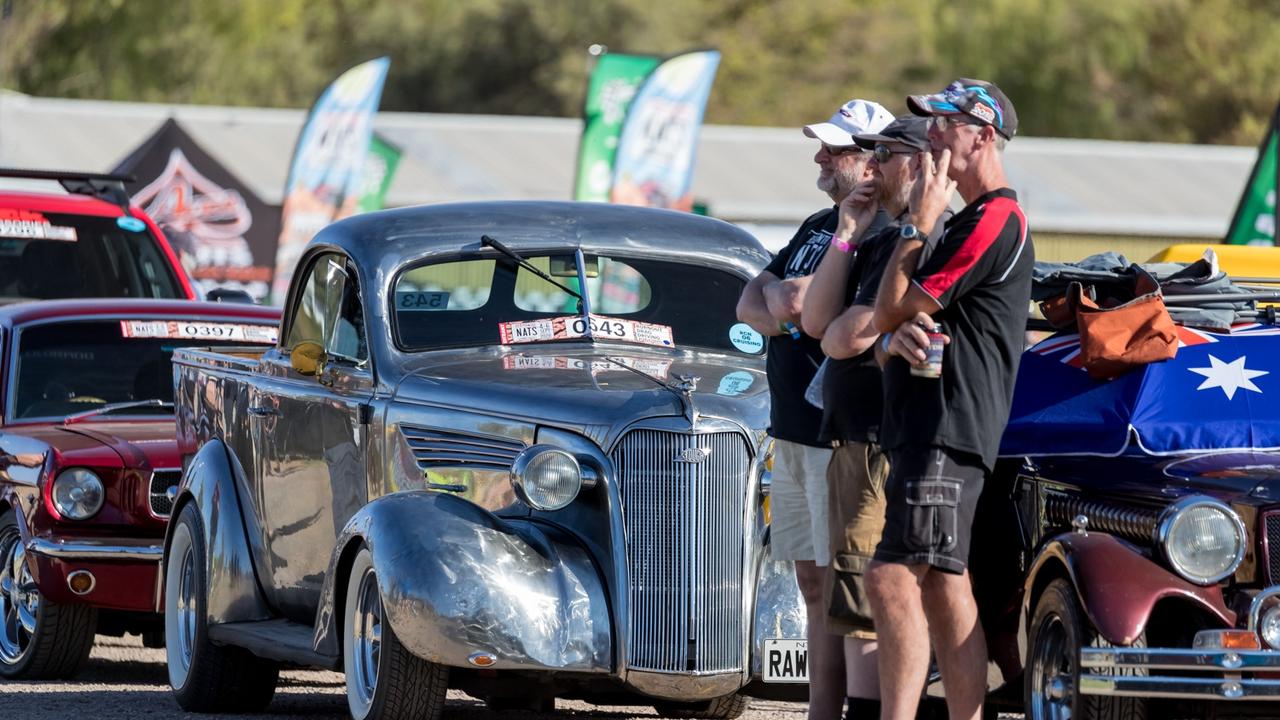 A group checks out cars on show at the Red CentreNATS. Picture: NT Major Events