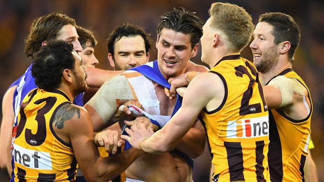 Tom Boyd wrestles with Hawks Cyril Rioli, James Sicily and James Frawley. Picture: Getty Images