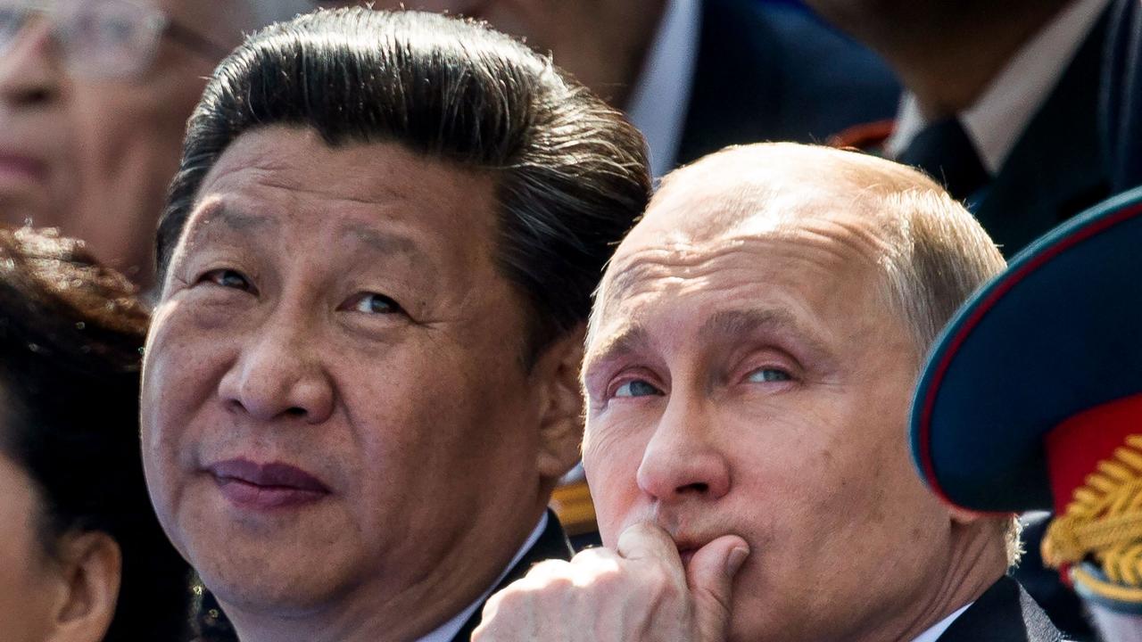 Russian President Vladimir Putin and Chinese President Xi Jinping watch the Victory Day military parade at the Red Square in Moscow on March 20, 2023. (Photo by ALEXANDER ZEMLIANICHENKO / POOL / AFP)