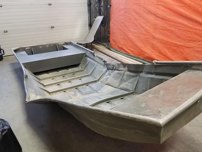 A damaged aluminium boat police found on the shore of the Nelson river while they were searching for Kam McLeod and Bryer Schmeglsky. Picture: AFP