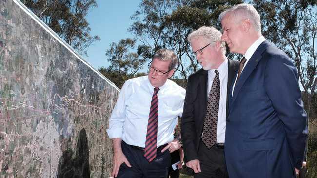 Groom MP Dr John McVeigh, ARTC Inland Rail Programme CEO Richard Wankmuller, and Deputy Prime Minister Michael McCormack look over plans for the Inland Rail.