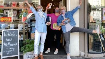 Sue Martin (left) and Wenche Osland (far right) are happy to welcome customers back in store at Book and Paper post lockdown.