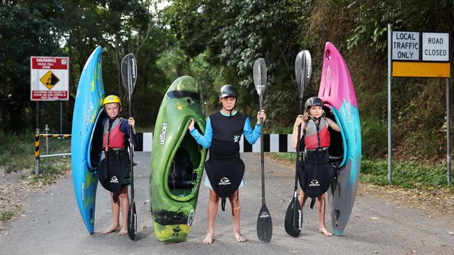 Recreational kayakers are angry that the Barron Gorge Road at Caravonica remains closed to traffic, more than 10 months on from the flood. Junior kayakers Teddy Berry, 9, Angus Gonzo, 11, and Kitty Berry, 11. Picture: Brendan Radke