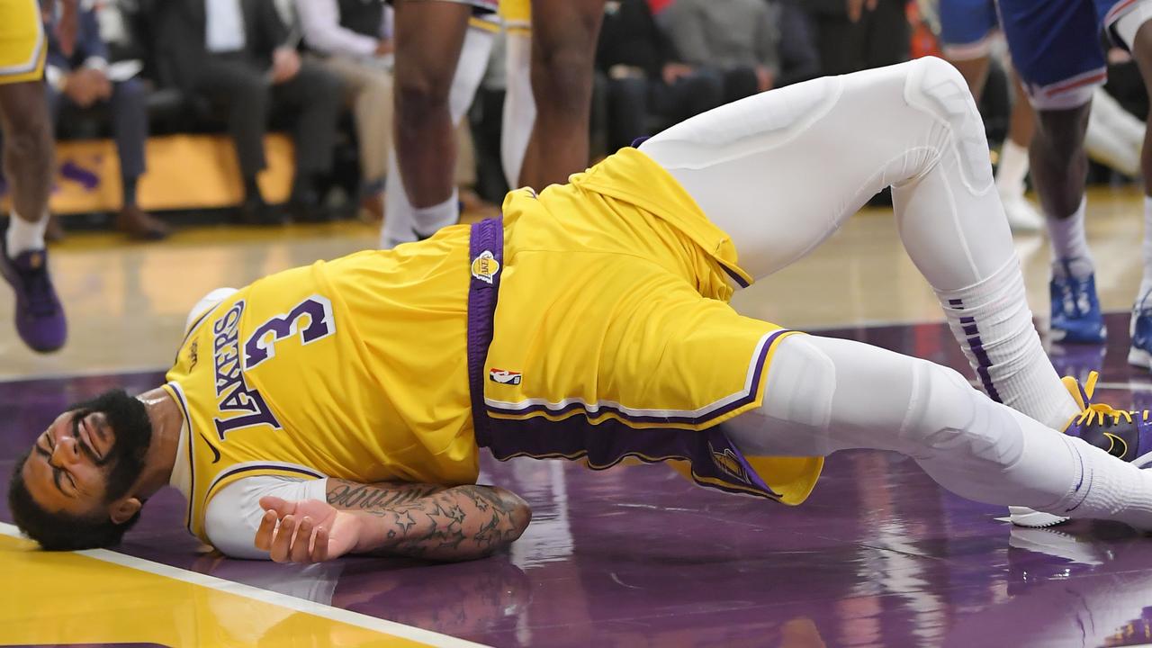 Los Angeles Lakers forward Anthony Davis winces after hitting the court hard.