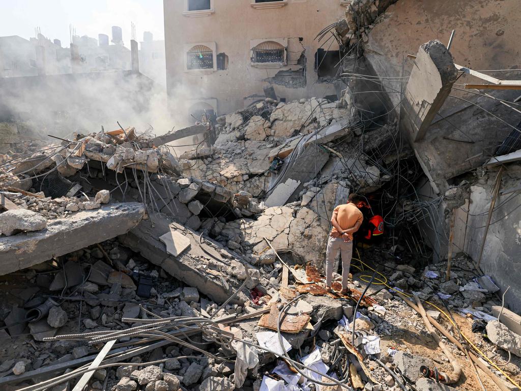 Palestinians look for survivors from under the rubble of a collapsed building following an Israeli strike, in Khan Yunis in the southern Gaza Strip on October 14, 2023. Picture: Mahmud HAMS / AFP