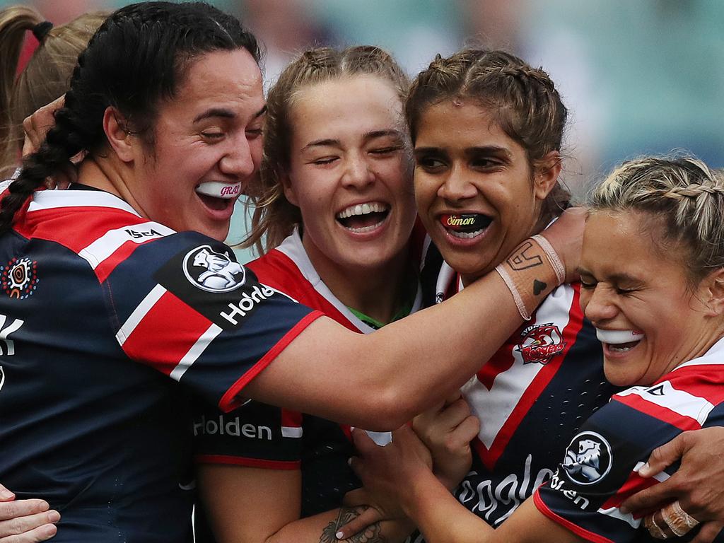 Julia Robinson (centre) of the Broncos is tackled by Holli Wheeler (left)  and Jessica Sergis (right) of the Dragons during the NRL Women's  Premiership match between the Brisbane Broncos and the St