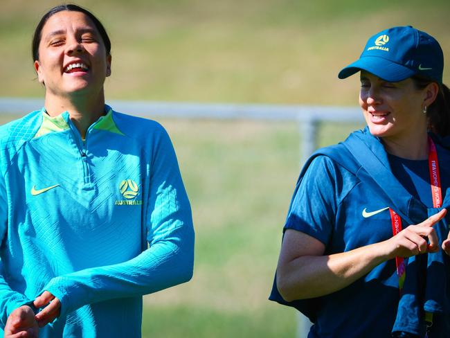 Injured Australian captain Sam Kerr (L) walks with a staff member during a training session in Brisbane. Picture: Patrick HAMILTON / AFP.