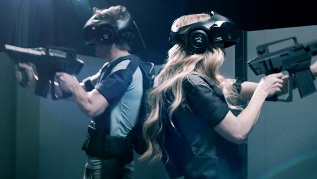 Users try out a prototype of The Void wearing the company’s Rapture VR headsets.