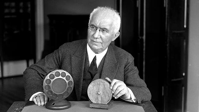 Emile Berliner in 1927 with the microphone he invented.