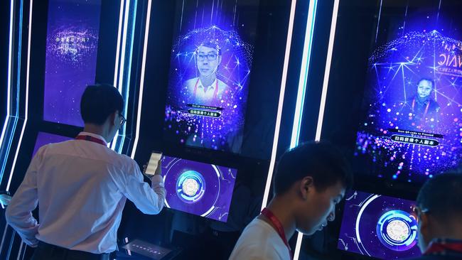 Attendees have their faces scanned as they arrive for the World Artificial Intelligence Conference in Shanghai in 2019.