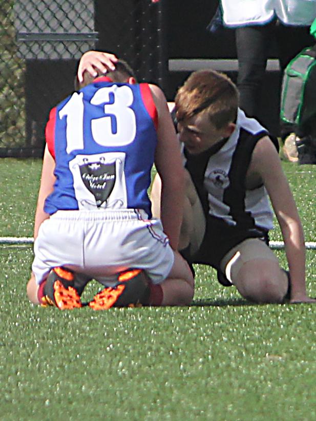 Logan Kemp consoles Liam Michael on the field.