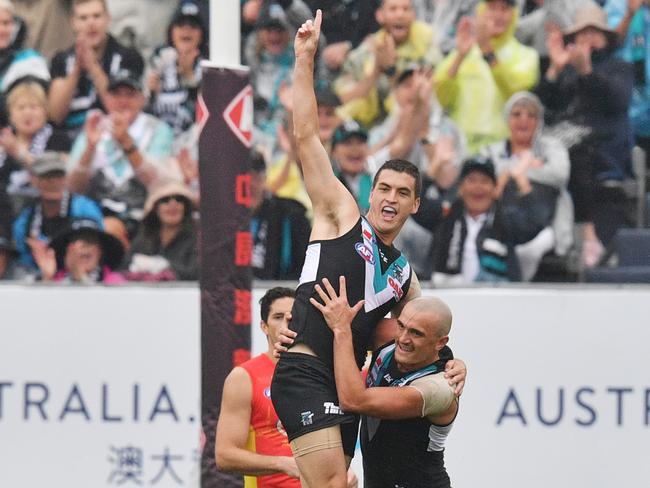 Tom Rockliff celebrates a goal as the Power proved too good in the end.