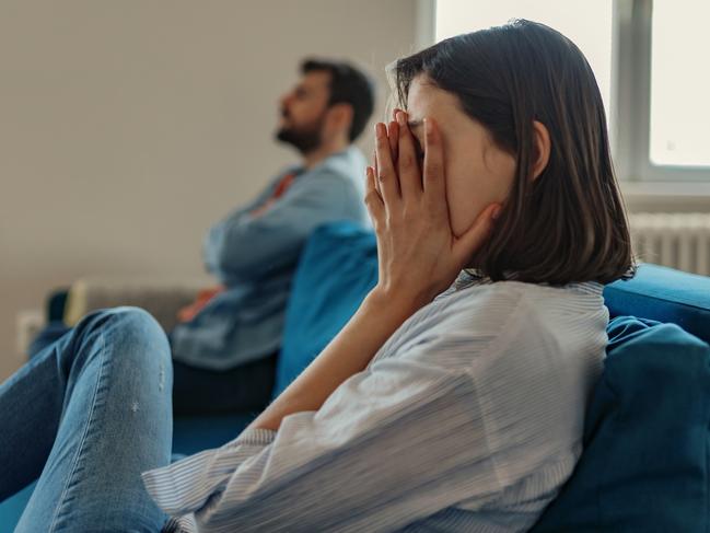 Unhappy Couple After an Argument in the Living Room at Home. Sad Pensive Young Girl Thinking of Relationships Problems Sitting on Sofa With Offended Boyfriend, Conflicts in Marriage, Upset Couple After Fight Dispute, Making Decision of Breaking Up Get Divorced istock image