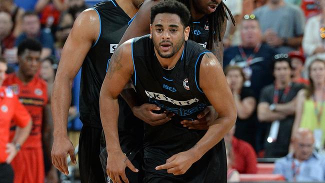 Teammates help NZ Breakers guard Corey Webster back to his feet after hurting his knee