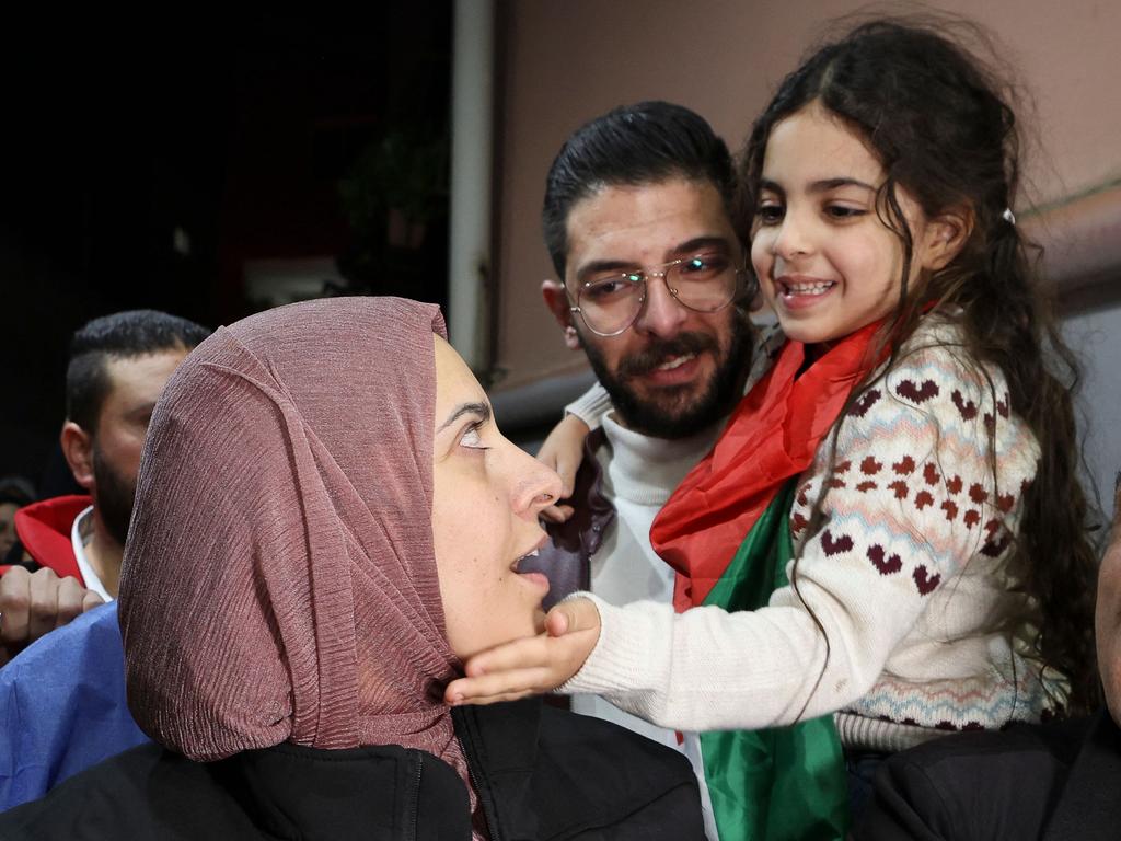 Aylool gently caresses mother Fatima's cheek after her release from an Israeli prison as part of a truce agreement between Israel and Hamas. Picture: Hazem Bader/AFP