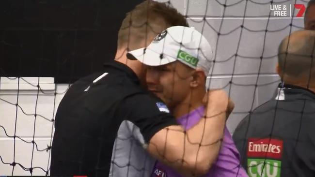 Nathan Buckley comforts Alex Woodward in the rooms after the game. Picture: Channel 7