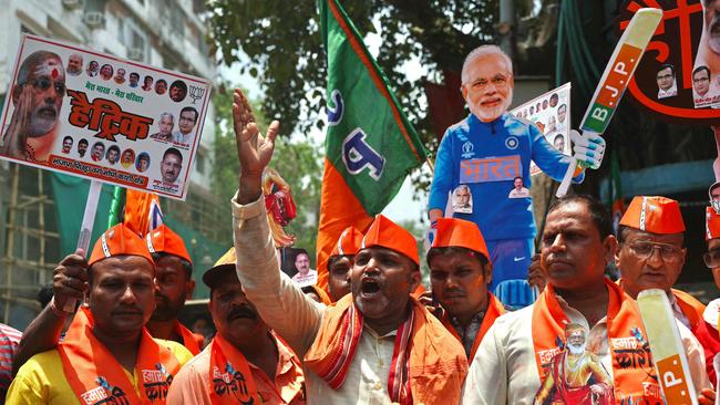 Supporters of Prime Minister Narendra Modi carry his cut-out as they celebrate vote counting results for India's general election in Varanasi on Tuesday. Picture: AFP