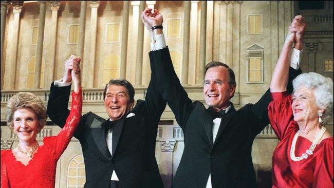 (FILES) In this file photo taken on November 05, 1988 US President Ronald Reagan, left, raises his arms in the air with presidential hopeful George Bush, center, whilte First Lady Nancy Reagan, left, and Barbara Bush, right, smile, after President Reagan announced endorsement for Bush as the next president of the United States in Washington DC. - George H.W. Bush -- the upper-crust war hero-turned-oilman and diplomat who steered America through the end of the Cold War as president and led a political dynasty that saw his son win the White House -- died Friday. He was 94. (Photo by MIKE SARGENT / AFP)